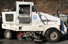 A white, single cab, street sweeper